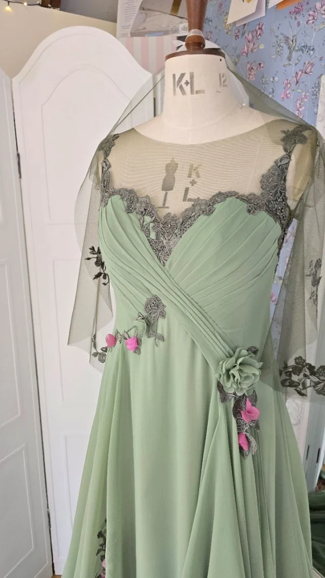 "Wedding dresses should be white…”

Only if you want them to be.

Tradition can be beautiful, but it’s not for everyone. Your wedding dress should reflect you. Your story, your style, your soul.

In my world, bridal gowns come in every shade you can dream of ✨

Amy’s green floral dress is a perfect example: soft green chiffon, layered with sage green lace and hand crafted flowers in pinks, greens, and a bold pop of orange. Romantic, elegant, and unapologetically her.

So tell me - if you could wear any colour on your wedding day, what would it be?

#bespokebride #nontraditionalbride #modernromantic #greenweddingdress #floralweddingdress #bridalwithoutrules #yourdressyourway #uniqueweddingdress #bridalinspo #yourdayyourway #fionaelizabethcouture #madewithmeaning #creativebride